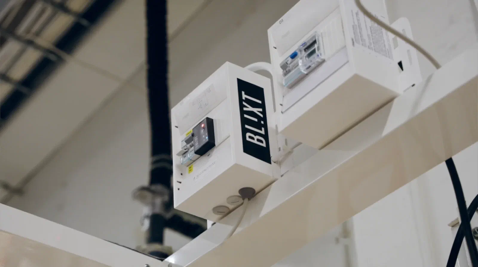 A Blixt-branded distribution box with a Zero unit installed above a manufacturing line